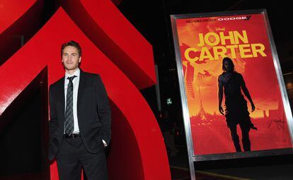 Actor Taylor Kitsch posing for the media at the premiere of 'John Carter'