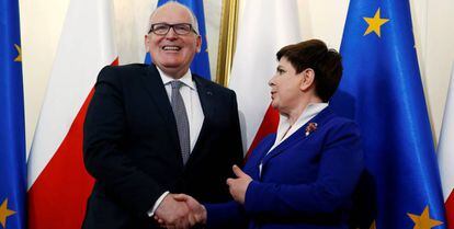 La primera ministro polaca Beata Szydlo estrecha la mano al vicepresidente de la Comisi&oacute;n Europea Frans Timmermans, el 24 de mayo en Varsovia.