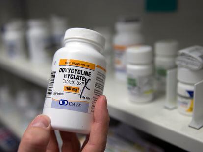 A pharmacist holds a bottle of the antibiotic doxycycline hyclate in Sacramento, Calif., July 8, 2016.