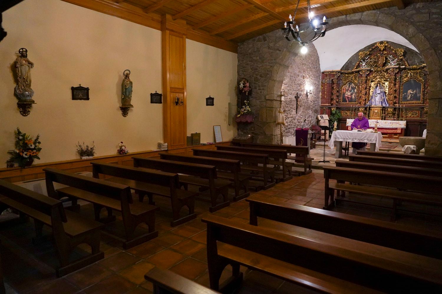 El padre Jorge da misa a diario solo en la parroquia de La Serna pero la retransmite con su móvil a través de Facebook.