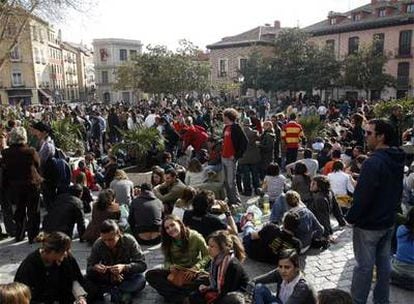 Jóvenes madrileños asisten a un <i>botellón</i> en la plaza de la Puerta de Moros del céntrico barrio de La Latina.