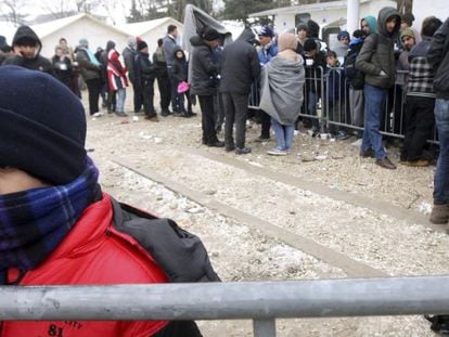 Refugiados sirios, iraqu&iacute;es y afganos caminan por un camino nevado en Miratovac, en la frontera entre Serbia y Macedonia.