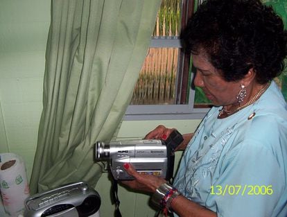 Dona Vitoria puts tape in her camcorder, on July 13, 2006.