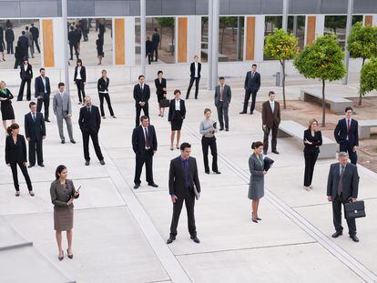 Businesspeople in modern office courtyard