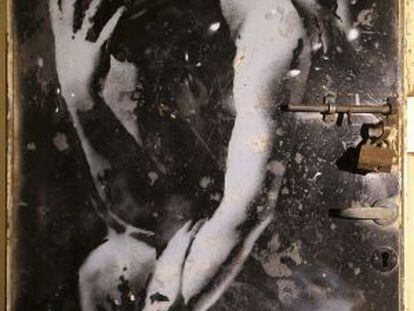La puerta de metal con el grafiti de una diosa griega pintado por Banksy.