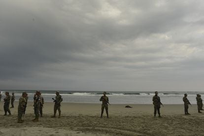 The Mexican Navy guards the body of an African migrant who died off the coast of Chiapas when his boat was shipwrecked.