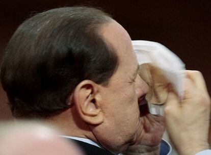 El primer ministro, Silvio Berlusconi, apela al camuflaje para retocarse el maquillaje durante una conferencia de empresarios italianos