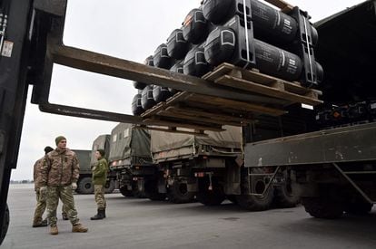Ukrainian soldiers load a truck with FGM-148 Javelins shipped from the US.  
