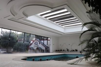 The indoor pool, under a skylight and overlooking the garden, where the playhouse is located.