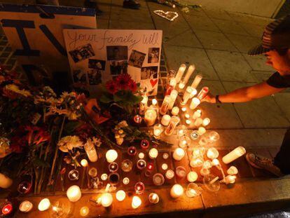 Un estudiante deja una vela por las v&iacute;ctimas de la masacre en Santa B&aacute;rbara. 