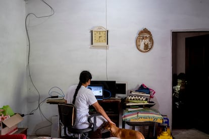 Doña Luz Análida Ríos Ospina (39) at her home in San Sebastián de Palmitas, Medellín, in front of the Mayor's Office technician's computer.