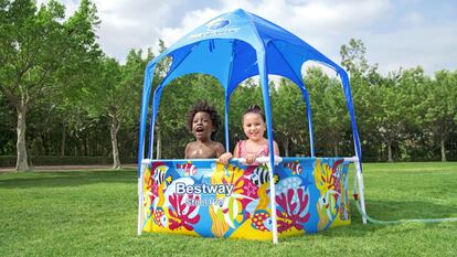 Two children have fun in one of the removable pools with a parasol included from the Bestway firm.