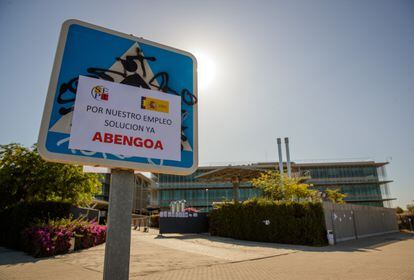 Demanding posters pasted on road signs in front of the Abengoa headquarters in Seville.