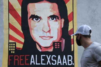 A man walks past a mural in support of Alex Saab in Caracas, Venezuela, last September.