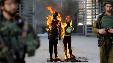 Manifestantes palestinos quemando efigies que representan al presidente de los Estados Unidos, Donald Trump, y al primer ministro israelí, Benjamin Netanyahu,en Cisjordania ocupada por Israel, el 28 de febrero.