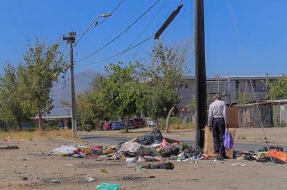 A man searches through garbage in Puente Alto, Santiago, Chile, on December 16, 2021.