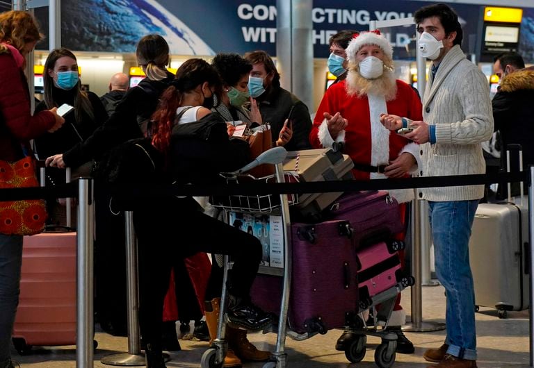 Travelers queue up at one of the London Heathrow airport terminals on December 21.