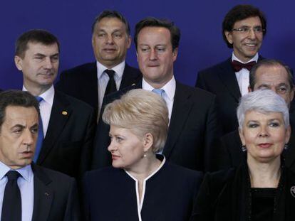 David Cameron (centro) mira a Nicolas Sarkozy durante la foto de familia de la cumbre europea.