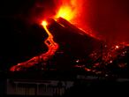 Lava flows next to a house following the eruption of a volcano in the Cumbre Vieja national park at El Paso, on the Canary Island of La Palma, September 19, 2021. Pictures taken September 19, 2021. REUTERS/Borja Suarez