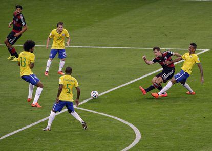 Miroslav Klose dispara a puerta rodeado de jugadores brasile&ntilde;os. 