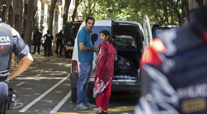 La parella desnonada al carrer del Parlament carrega les seves pertinences en una furgoneta.