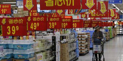 A woman shops at a supermarket in Beijing.