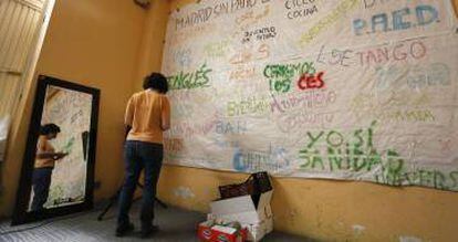 Una mujer realiza una pancarta en Patio Maravillas durante la okupación de un edificio en la calle del Divino Pastor.