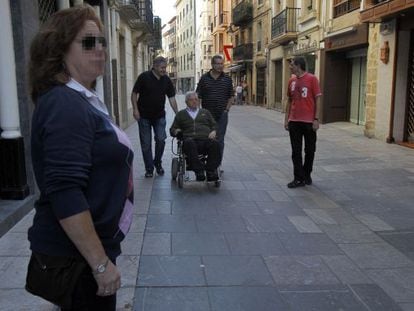 La escolta de Elola (al fondo, primero por la izquierda) vigila mientras el edil pasea con su familia.