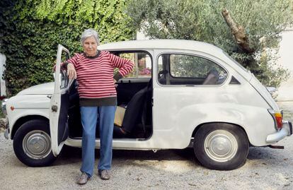 Teresa Muga, 78 years old, wearing “her” sweater next to the car with which she goes to a reception center every day.