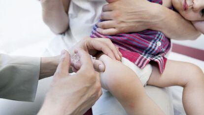 Un médico suministra una vacuna a un bebé.