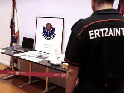 Un 'ertzaina' delante de los once kilos de heroína incautados en Bilbao.