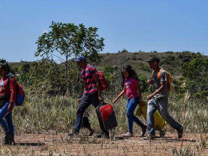Venezolanos caminan en Pacaraima, Brasil, tras cruzar la frontera. 