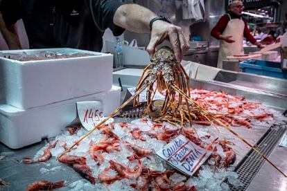 A worker displays products at a fisherman's market in Valencia.