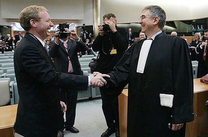 El abogado principal de Microsoft, Brad Smith (izquierda), y representante legal de la Comisión Europea estrechan sus manos tras conocer la sentencia del Tribunal de Luxemburgo.