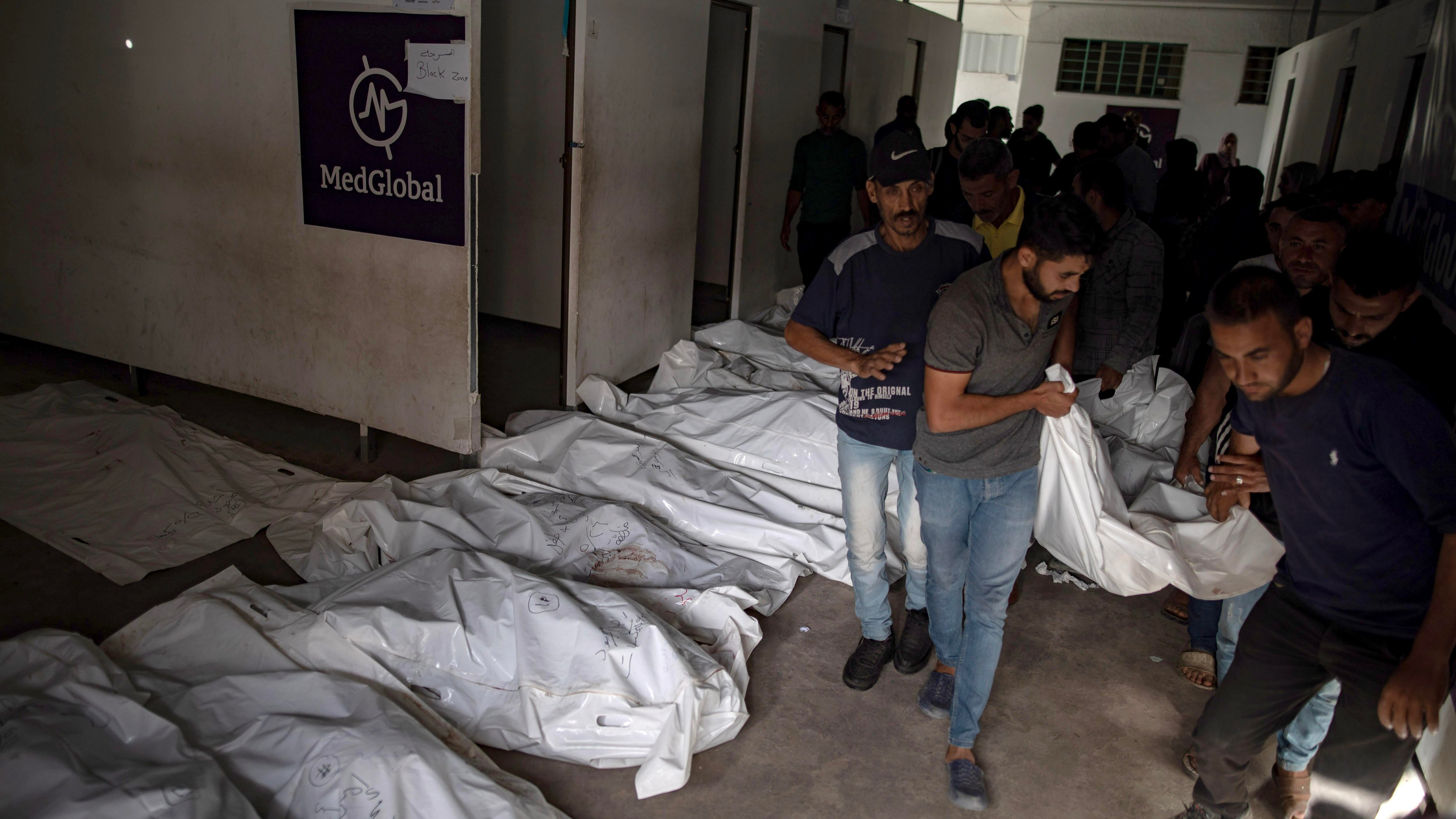 Palestinians carry bodies after an Israeli army raid on a camp at an area designated for displaced people in Rafah, southern Gaza Strip, 27 May 2024. At least 40 people were killed after Israeli airstrikes hit an area in Rafah designated for the displaced, the Palestinian Civil Defense said. More than 35,000 Palestinians and over 1,400 Israelis have been killed, according to the Palestinian Health Ministry and the Israel Defense Forces (IDF), since Hamas militants launched an attack against Israel from the Gaza Strip on 07 October 2023, and the Israeli operations in Gaza and the West Bank which followed it. EFE/EPA/HAITHAM IMAD