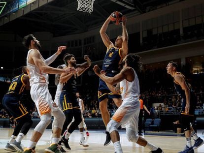 Bertans se hace con la pelota entre rivales del Baskonia.