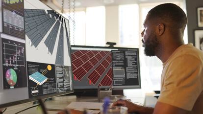 Close up stock image of an African American man working at a computer screen