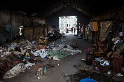 Un viejo hangar en ruinas da cobijo a varias familias, que viven entre los despojos que encuentran en Freetown, Sierra Leona.