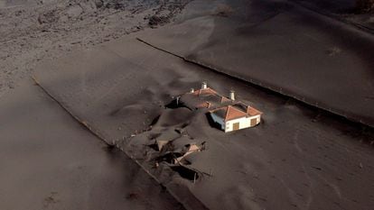 Aerial image of a house covered by lava and ash on La Palma on December 14.
