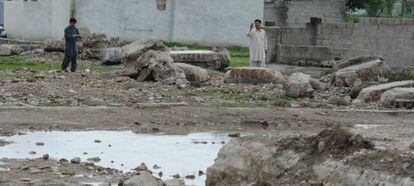 Unos hombres toman fotos de los restos de la casa de Bin Laden, en Abbottabad, demolida hace un mes por las autoridades paquistan&iacute;es.