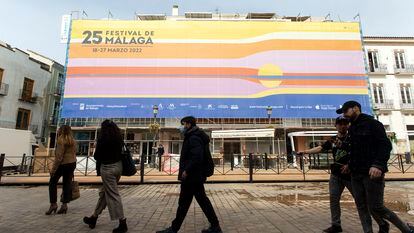 Varias personas caminaban ayer frente a carteles y lonas que anuncian el Festival de Málaga.