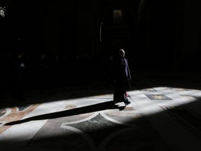 Un sacerdote pasea por el interior de la basílica de San Pedro.
