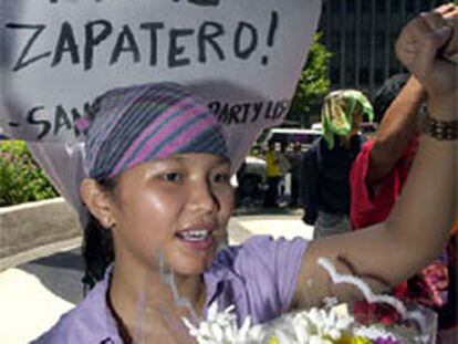 Una mujer protesta en Manila delante de un cartel: "Brillante decisión, Zapatero".