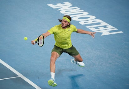Greece's Stefanos Tsitsipas hits a backhand return to Spain's Rafael Nadal during their quarterfinal match at the Australian Open tennis championship in Melbourne, Australia, Wednesday, Feb. 17, 2021.(AP Photo/Andy Brownbill)