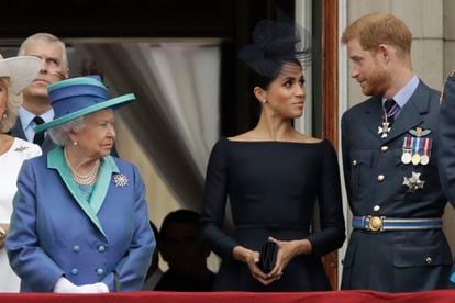 La reina Isabel II (a la izquierda) observa a Meghan Markle y Enrique de Inglaterra en el balcón del palacio de Buckingham, en julio de 2018.