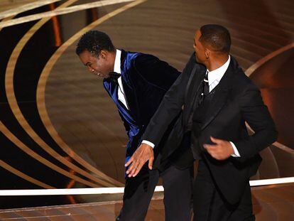 (FILES) In this file photo taken on March 27, 2022 US actor Will Smith (R) slaps US actor Chris Rock onstage during the 94th Oscars at the Dolby Theatre in Hollywood, California. - The Oscars were in desperate need of a ratings boost -- and, on a night when Will Smith stunned viewers by slapping Chris Rock on stage, some 15.36 million Americans tuned in. (Photo by Robyn Beck / AFP)