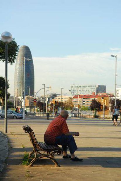 Un hombre sentado en un banco en Barcelona.