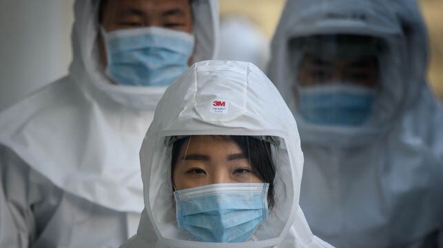 In this photo taken on March 12, 2020, medical workers wearing protective clothing against the COVID-19 novel coronavirus walk to a decontamination area at the Keimyung University hospital in Daegu. - South Korea -- once the largest coronavirus outbreak outside China -- saw its newly recovered patients exceed fresh infections for the first time on March 13, as it reported its lowest number of new cases for three weeks. (Photo by Ed JONES / AFP)