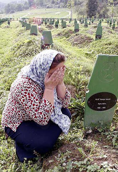 Una  bosnia reza, ayer, ante la tumba de un hermano muerto en Srebrenica.