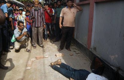 Varias personas, alrededor del cad&aacute;ver del profesor asesinado este s&aacute;bado en Rajshahiel.